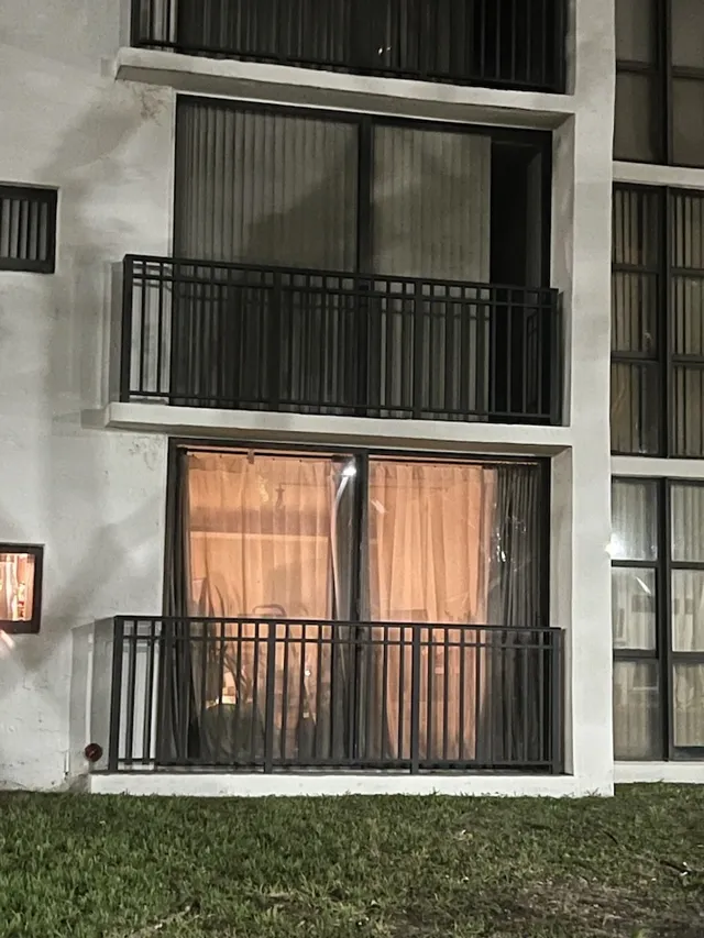 Stacked balconies with sliding glass doors and dark railings