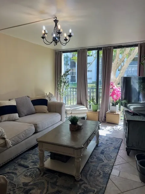 Sliding glass doors beside a sofa, opening toward a patio