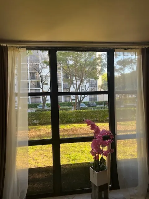 Dark-framed glass patio door with a garden visible outside